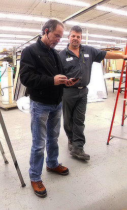 Logistics — Bob and me preparing to load the truck with high-end elevator finishes for delivery to 44 King Street, Toronto, the historic Bank of Nova Scotia building, now part of Scotia Plaza.  I'm probably calculating the best route, since there is usually several stops to make.