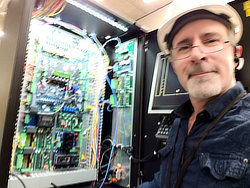 Bridging the gap between promise and execution at Manulife.  Delivering a project this technologically advanced —one that had never been accomplished in Canada and only once in the USA— required me to wear multiple hats: Project Coordinator, Network Engineer, and Systems Integrator. Here I am up in the Manulife elevator machine room —where the mechanical and electronic equipment resides to make the elevator function— and I'm smiling for two reasons: the project finish line is finally in sight, and I am about to prove the 'technically impossible' very much possible. By personally landing the final connections to the bank's network, I ensured that the vision I pitched to stakeholders was exactly what we delivered.