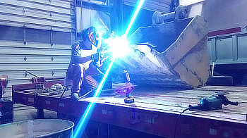 Modifying a large excavator bucket for a special job.  I'm working into the night to ensure it is ready for the crew in the morning.