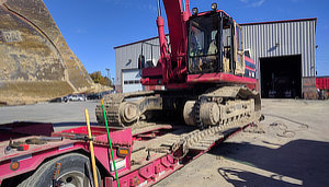 Splitting the track to replace a final drive sprocket (the round black pointy thing in the middle of the photo) on a Cat 330 Excavator